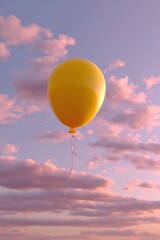 Obraz premium Bright yellow helium balloon floating skyward du sunset with pink clouds in the background creating a serene and whical outdoor scene