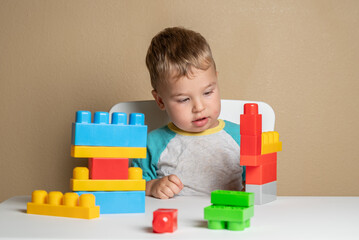 Curious Toddler Observes Colorful Plastic Shapes