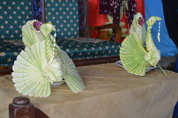 A traditional wedding decoration made from young coconut leaves, skillfully woven into elegant...