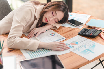 Stressed professional analyzes financial reports while struggling to stay awake amidst piles of...