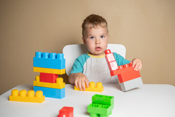 Curious Toddler Observes Colorful Plastic Shapes