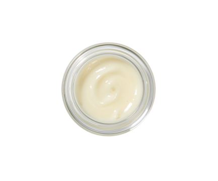 Overhead shot of a clear glass jar filled with a creamy lotion designed to moisturize the skin for a soothing bedtime routine