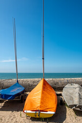 Wissant, Pas-de-Calais, Hauts-de-France, France, July 29th, 2025, Colorful and vibrant sailing boats are resting peacefully on the sandy beach under a bright clear blue sky