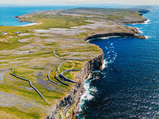 Aerial view of Inis Mór Arran Island with cliffs and ruins of Dun Aengus ancient stone fort Ireland