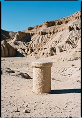 Desert stone pillar under clear blue sky
