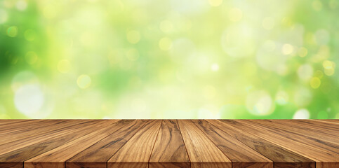 Wooden worktop with soft green bokeh background and natural light, ideal for product display.