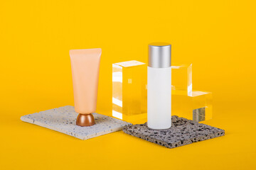 Plastic white tube for cream or lotion. Skin care or sunscreen cosmetic with stylish props on...