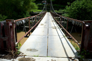 A narrow old hanging bridge in the forest in Gunung Kidul, Yogyakarta, Indonesia