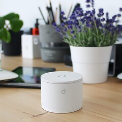 Minimalist workspace featuring a modern white cylindrical device amid decorative elements
