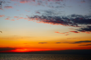 sunset in the sea. Beautiful colorful sky and cloud in twilight time background. Orange fluffy clouds and sun sunlight reflection in the blue