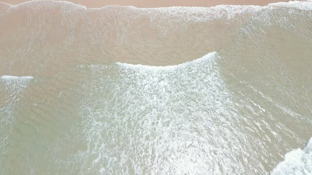 The waves roll in onto a golden beach