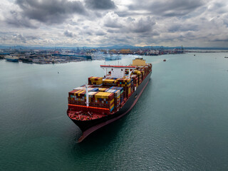 logistic cargo container ship sailing in sea to import export goods and distributing products to...