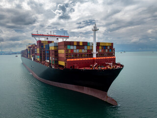 logistic cargo container ship sailing in sea to import export goods and distributing products to dealer and consumers across worldwide,