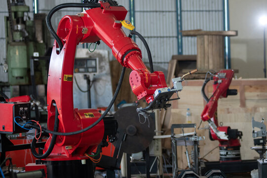 Advanced red industrial robotic arm machinery in modern smart factory