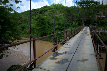 A narrow old hanging bridge in the forest in Gunung Kidul, Yogyakarta, Indonesia