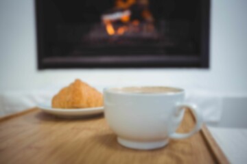 Close up of tea cup by food in plate on table