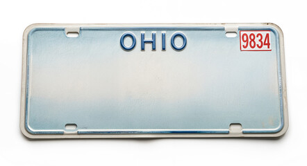 A vintage Ohio license plate with blue text on a faded blue background reads A red and white sticker displays "Text Space" in the top right