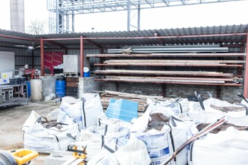 White bulk bags are being shown in flat design storage area, with pipes and pallet jack