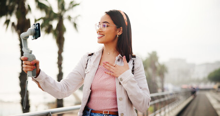 Phone gimbal, content creation and woman in city for travel, broadcast or tourism guide. Mobile,...