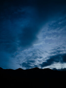 Dramatic Evening Sky Over Mountain Silhouette