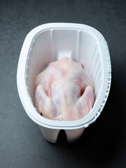 Fresh raw chicken in a container