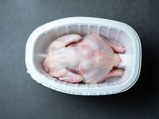 Fresh raw chicken in a container