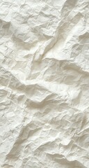 Fototapeta premium Close-up of heavily creased, off-white fabric with a textured, rumpled surface showing deep folds and shadows