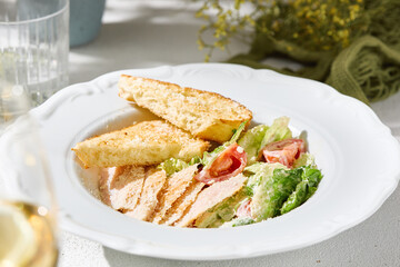 Caesar salad with chicken, bright natural lighting, overhead composition, crisp greens and toasted bread