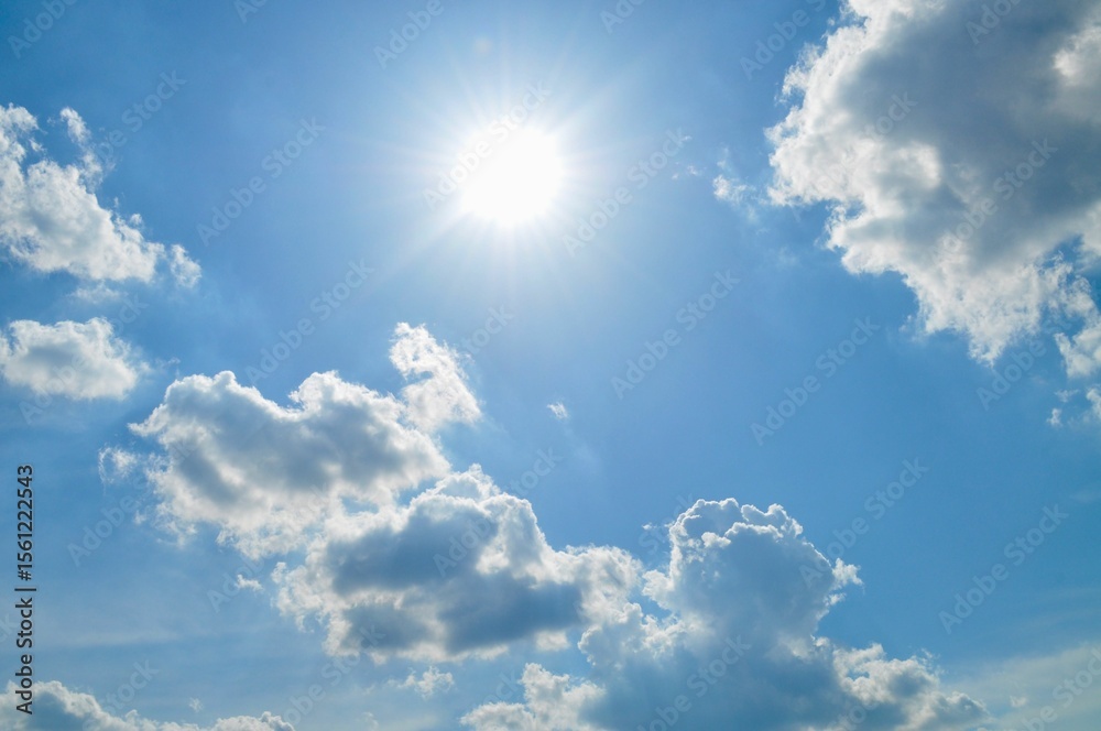 Wall mural scenic view of white clouds against a bright blue sky create a serene atmosphere