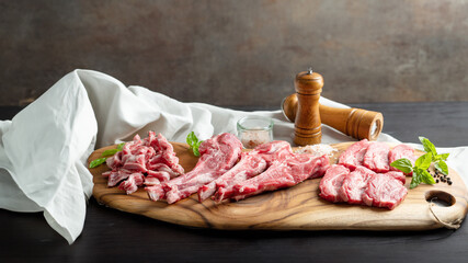 Raw lamb meat in various parts on a wooden plate