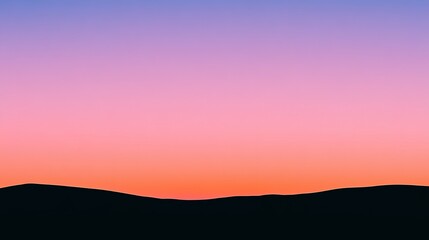 Fototapeta premium Silhouette of mountains against a vibrant sunset sky.