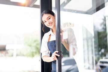 Small business owner at entrance looking at camera
