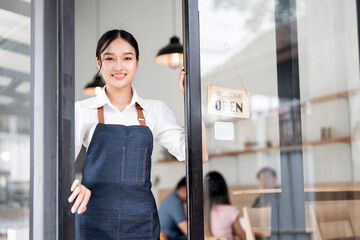 Small business owner at entrance looking at camera