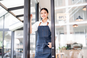 Small business owner at entrance looking at camera