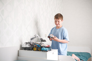 A young child joyfully playing with colorful toy trucks in a modern, stylish bedroom space