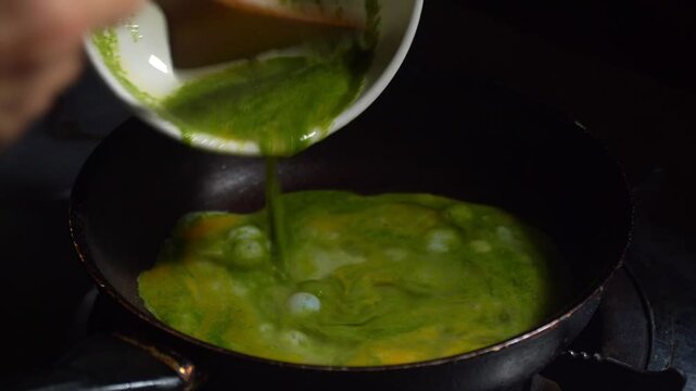 Chef cooking Super food. An omelet with Wolffia globosa, the nutrient rich plant. High quality plant protein, omega 3 and vital minerals. 
