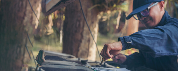 Banner Close up Mechanic man hands repairing car auto repair shop. Banner Man hands fixing...
