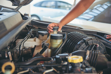 Close up Man hands fixing Car machinery vehicle mechanical service. Mechanic man hands repairing...
