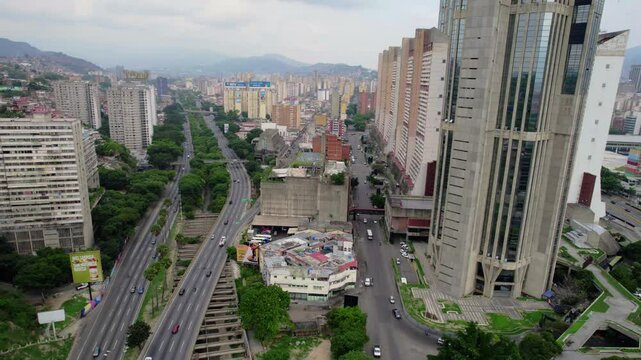 Explore the urban landscape of Caracas as we fly over Complejo Parque Central and the Metrocable.