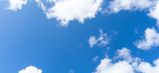 Low angle view of beautiful blue sky with strange shape of fluffy white clouds in the morning or...