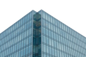 Modern glass building facade with a sharp corner against a bright white sky background