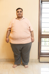 Overweight obese indian man standing looking at camera. Front view of Plus size fat guy. Obesity and weight loss.concept.