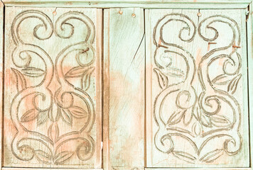 Intricate wooden carving showcases elegant floral design from a historical building