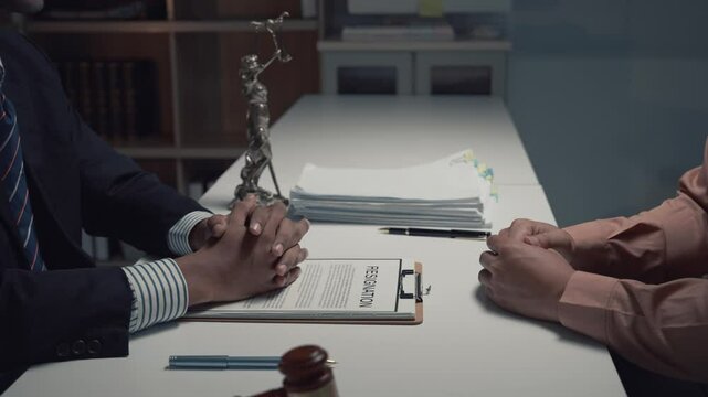 Experienced lawyers finalizing resignation agreement while professionally shaking hands inside corporate law office, signaling mutual legal consent and settlement