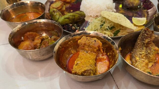 Bengali fish thali with rice, lentils, papad , potato served in wedding 