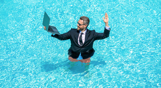 Freelance man online video call, hello. Freelance working online. Man using laptop for freelancing in swimming pool. Business freelancing. Businessman on summer vacation. Businessman calling on video