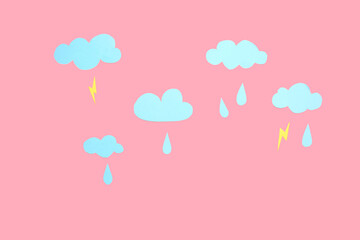 Paper clouds with rain drops and lightnings on pink background. Weather forecast concept