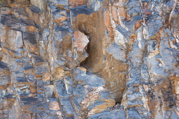 The rock layer broke in the cliff.