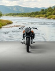 Obraz premium Mockup of a classic motorcycle parked beside a calm riverside landscape. Ideal for peaceful, nature-themed automotive presentations.