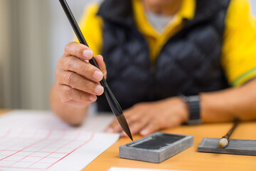 Elderly Asian Man Doing Traditional Chinese Calligraphy